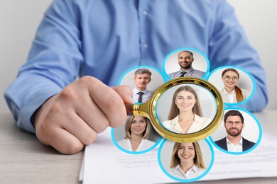 Image of Recruiter looking at candidate's photo through magnifying glass at table, closeup. Human resources management