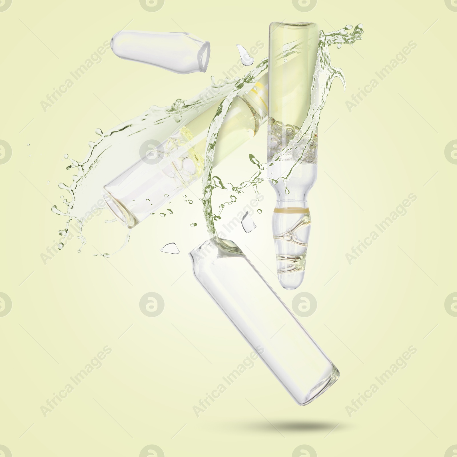 Ampoules and splash of medical or cosmetic liquid in air against beige background Image of Ampoules and splash of medical or cosmetic liquid in air against beige background