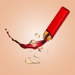Image of Broken ampoule and splash of medical or cosmetic liquid in air against pink beige background
