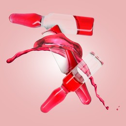 Image of Ampoules and splash of medical or cosmetic liquid in air against pink background