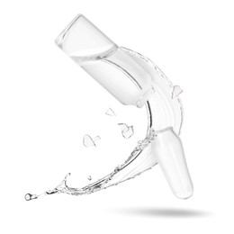 Image of Broken ampoule and splash of medical or cosmetic liquid in air against white background
