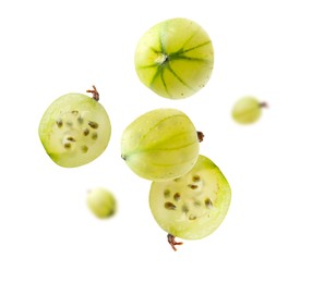 Image of Fresh green gooseberries falling against white background