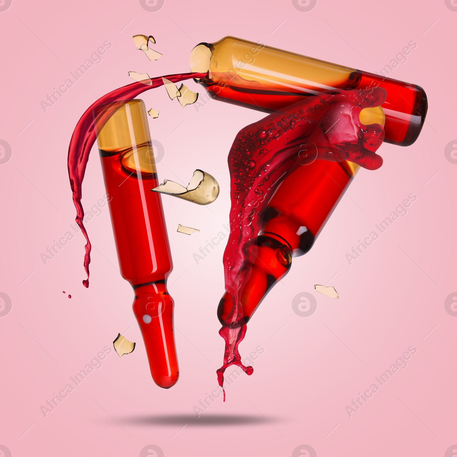 Ampoules and splash of medical or cosmetic liquid in air against pink background Image of Ampoules and splash of medical or cosmetic liquid in air against pink background
