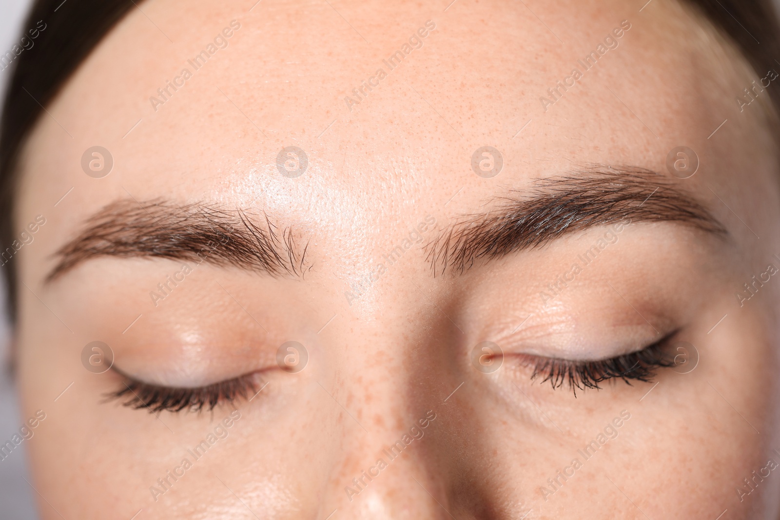Photo of Eyebrow styling. Young woman with beautiful eyebrows, closeup