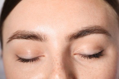 Photo of Eyebrow styling. Young woman with beautiful eyebrows, closeup