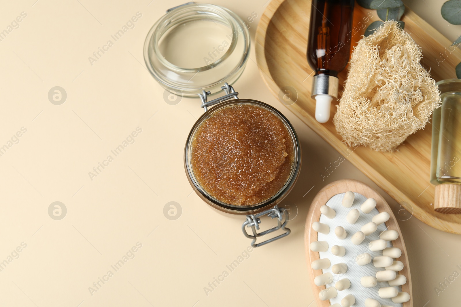 Photo of Natural body scrub and bath products on beige table, flat lay. Space for text