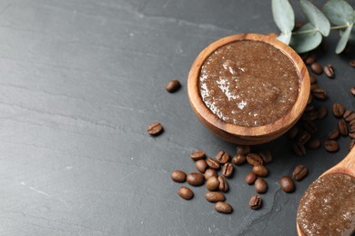 Photo of Natural body scrub, coffee beans and eucalyptus leaves on black table, above view. Space for text