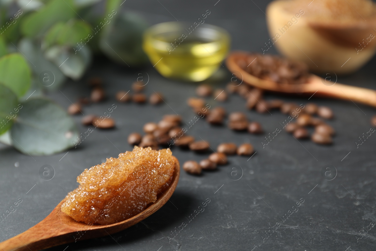 Natural body scrub and ingredients on black table, closeup Photo of Natural body scrub and ingredients on black table, closeup
