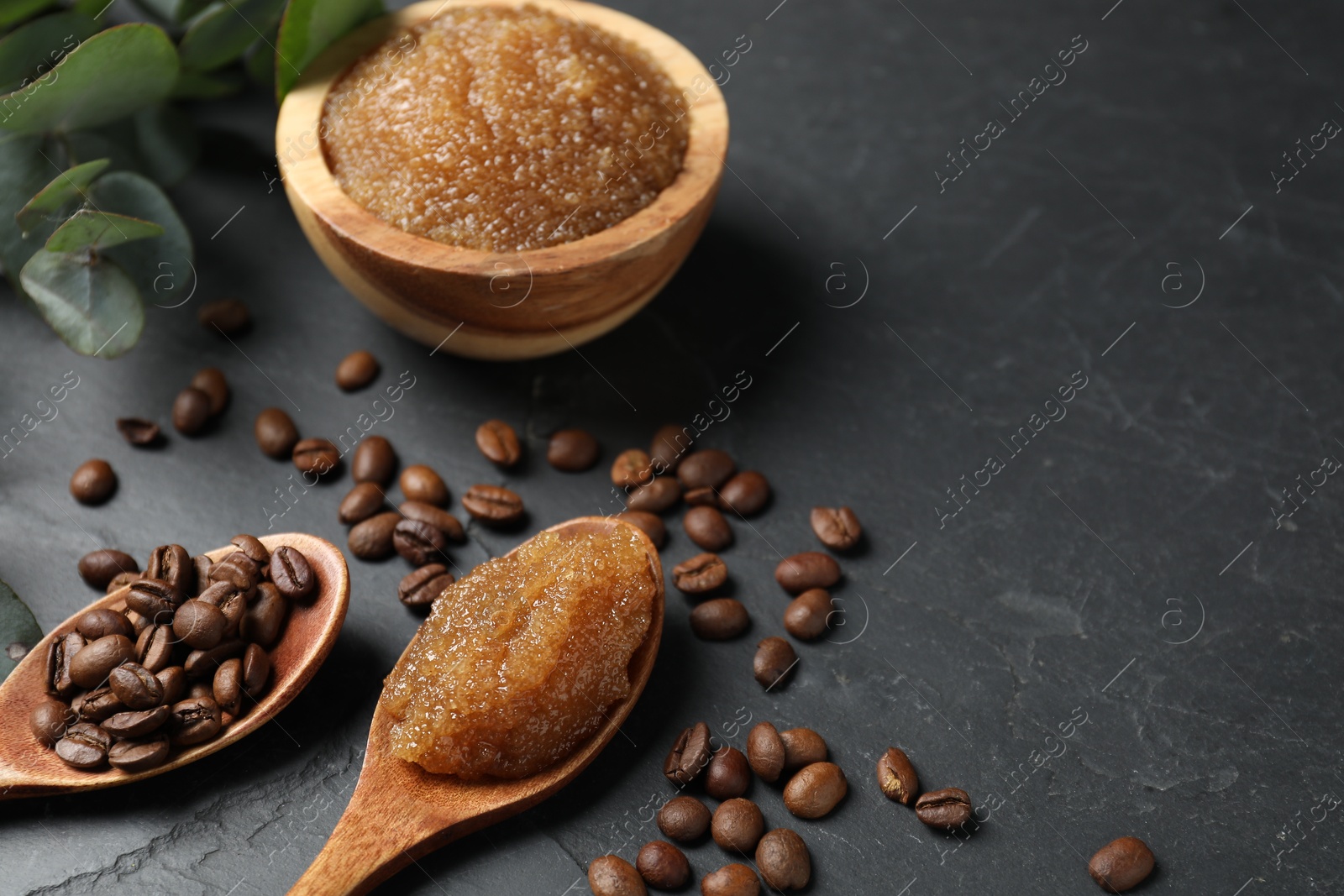 Natural body scrub and ingredients on black table, closeup. Space for text Photo of Natural body scrub and ingredients on black table, closeup. Space for text