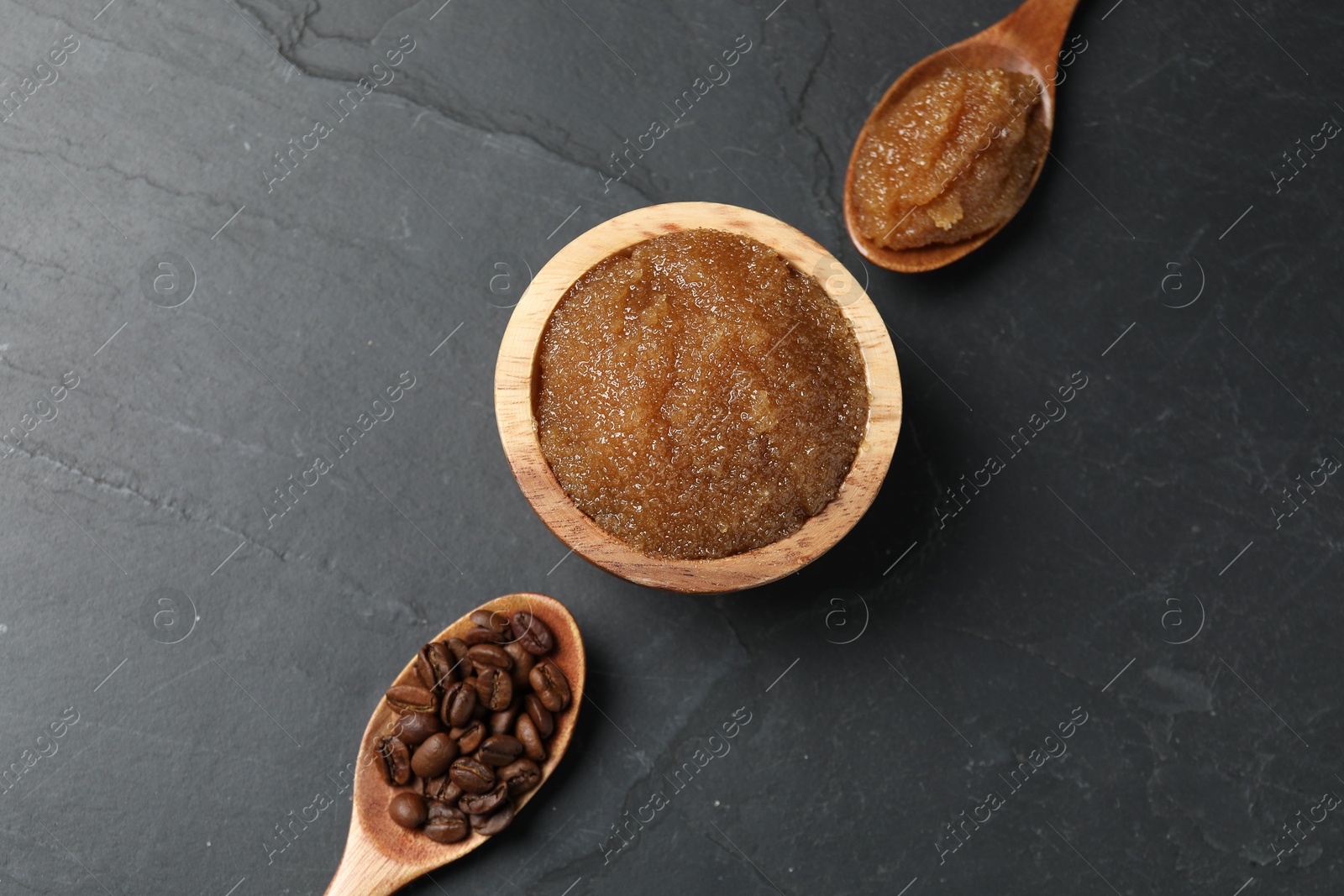 Natural body scrub and coffee beans on black table, flat lay Photo of Natural body scrub and coffee beans on black table, flat lay