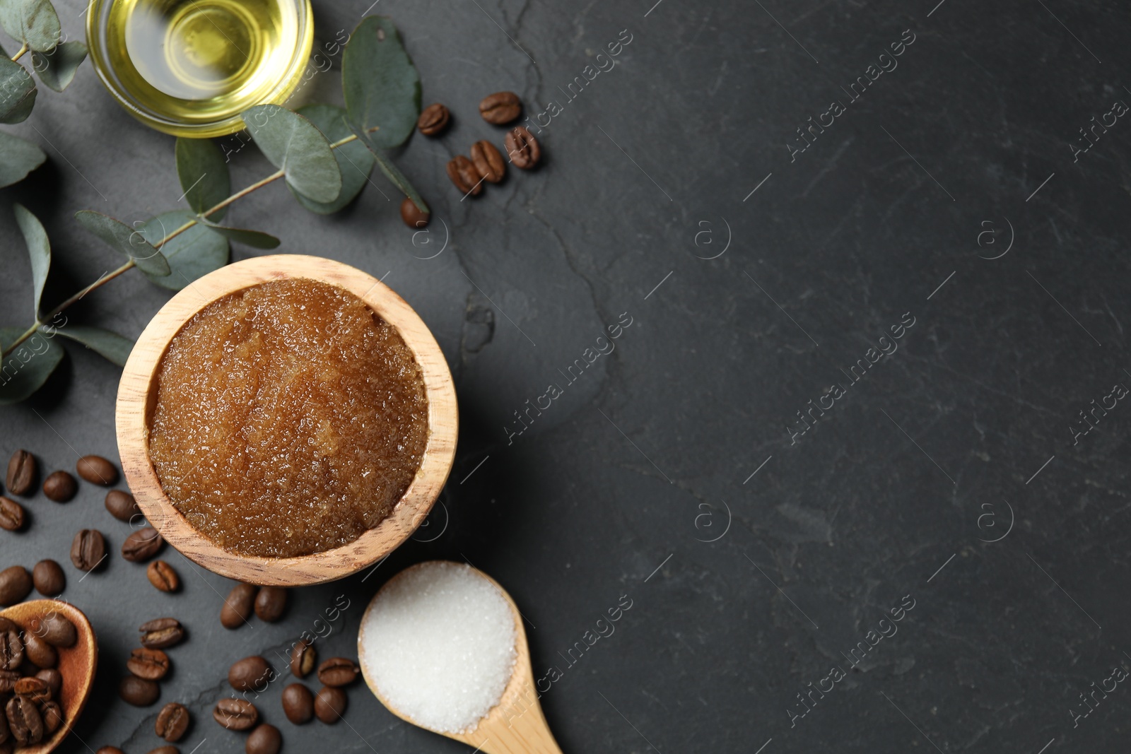 Natural body scrub and ingredients on black table, flat lay. Space for text Photo of Natural body scrub and ingredients on black table, flat lay. Space for text