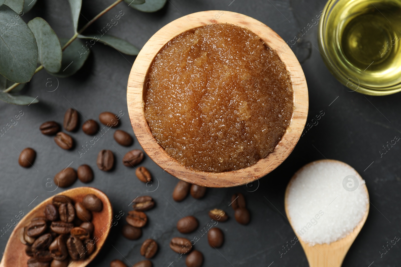 Natural body scrub and ingredients on black table, flat lay Photo of Natural body scrub and ingredients on black table, flat lay
