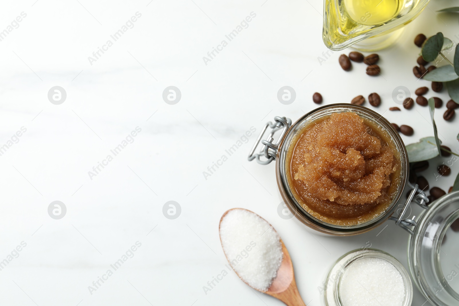 Natural body scrub and ingredients on white table, flat lay. Space for text Photo of Natural body scrub and ingredients on white table, flat lay. Space for text