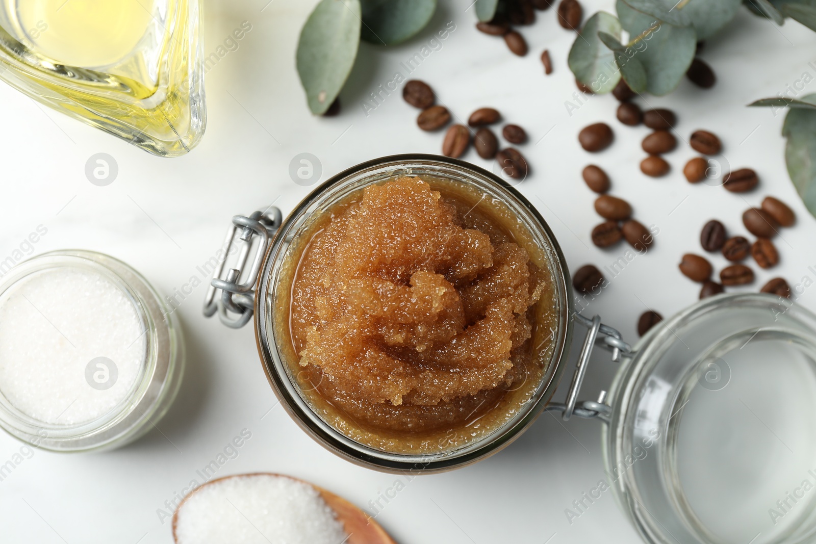 Natural body scrub and ingredients on white table, flat lay Photo of Natural body scrub and ingredients on white table, flat lay