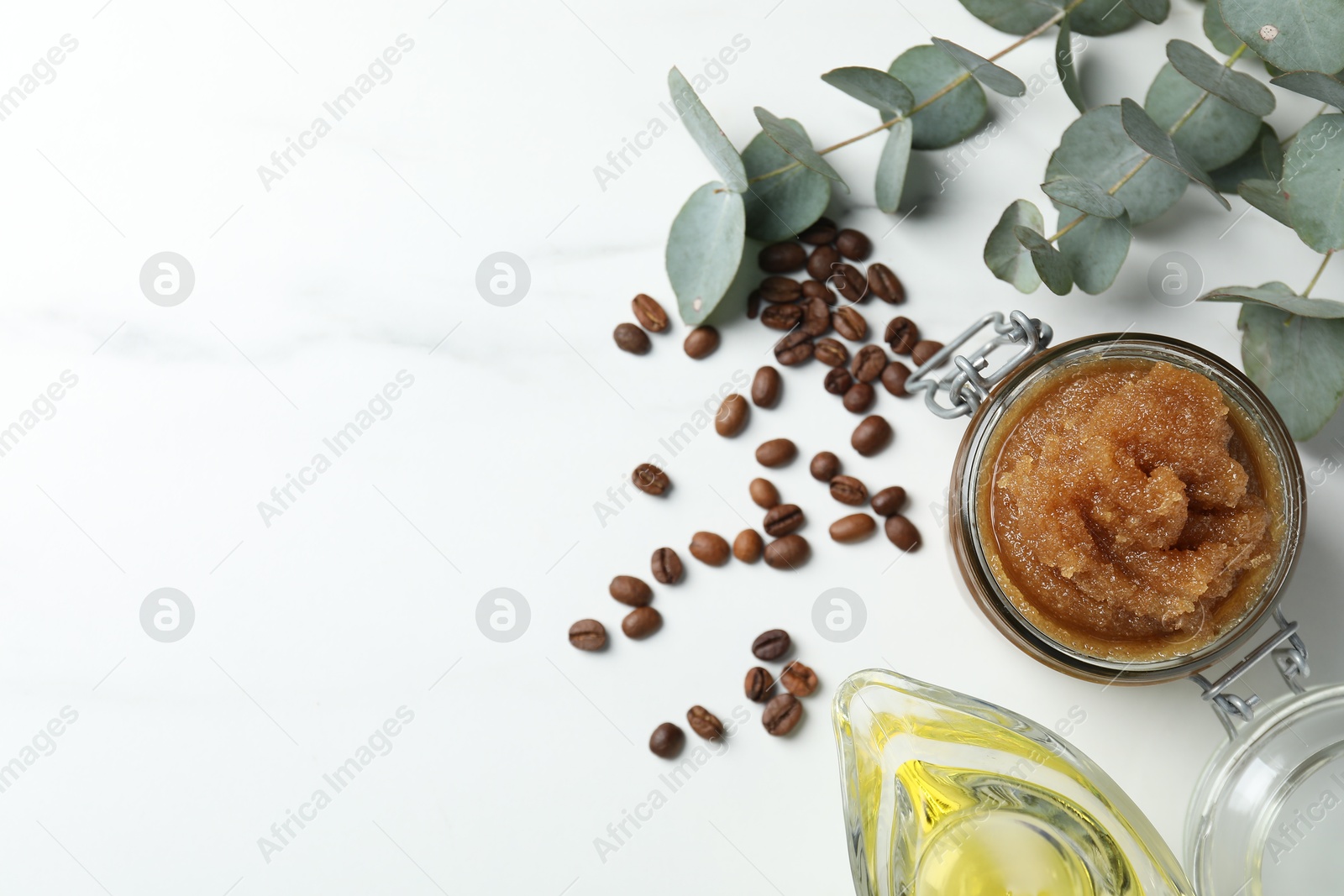 Natural body scrub and ingredients on white table, flat lay. Space for text Photo of Natural body scrub and ingredients on white table, flat lay. Space for text