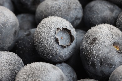 Photo of Many frozen blueberries as background, macro view