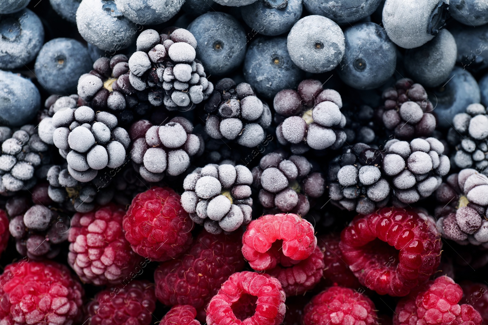 Photo of Many different frozen berries as background, top view