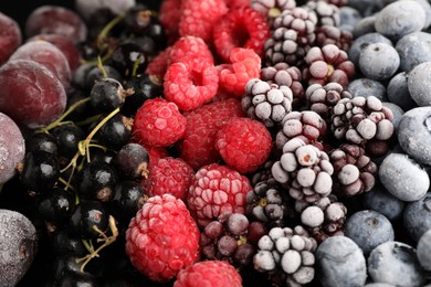Photo of Many different frozen berries as background, closeup