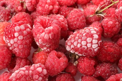 Photo of Many frozen raspberries on table, top view
