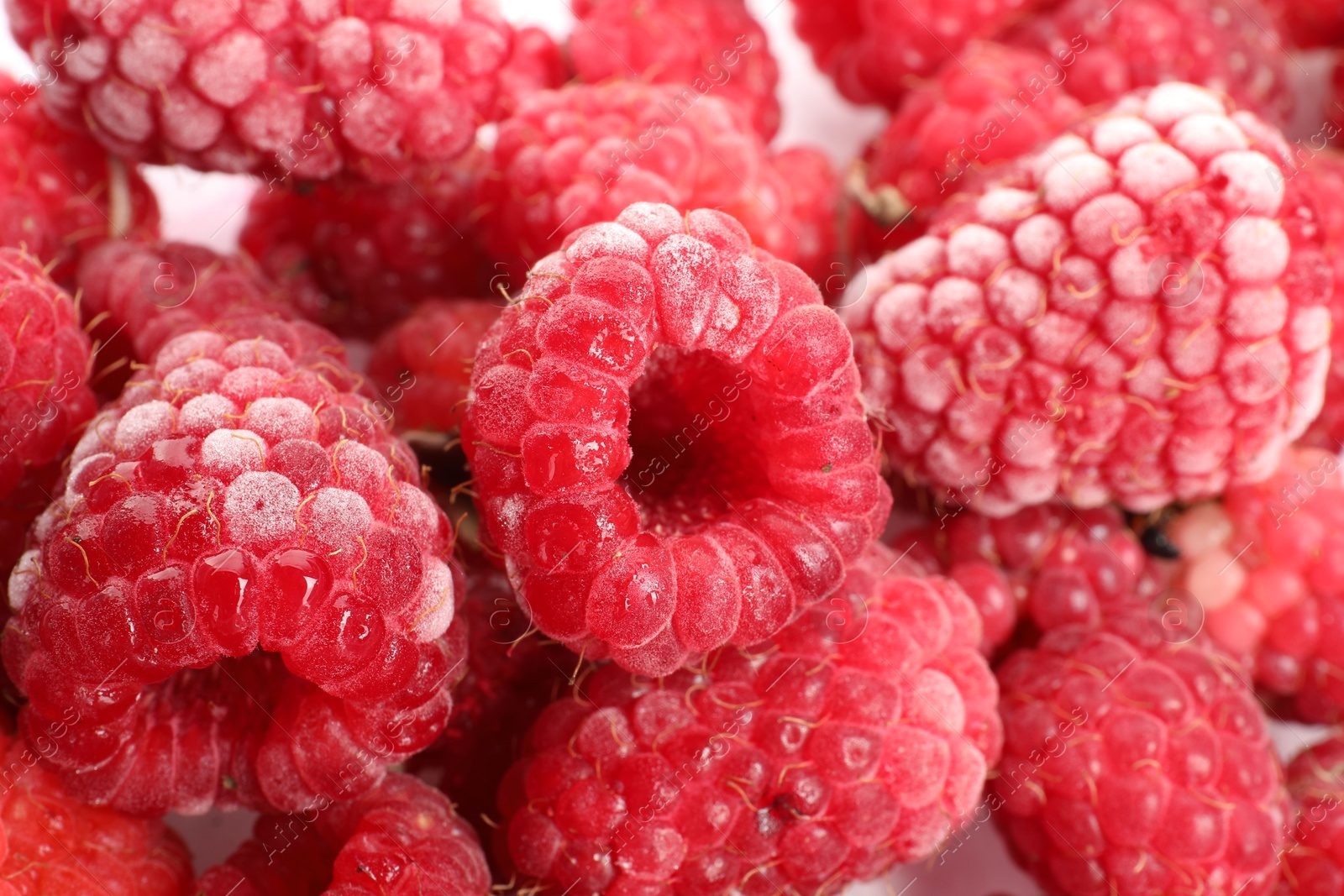 Photo of Many frozen raspberries on table, top view