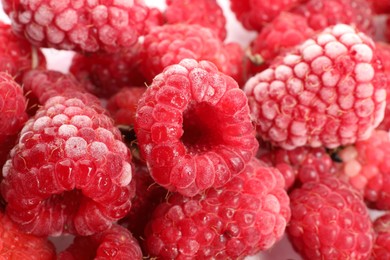 Photo of Many frozen raspberries on table, top view
