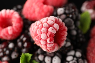 Photo of Many different frozen berries and mint on background, top view