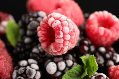 Photo of Many different frozen berries and mint on table, closeup
