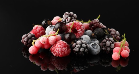 Photo of Many different frozen berries on black table, closeup