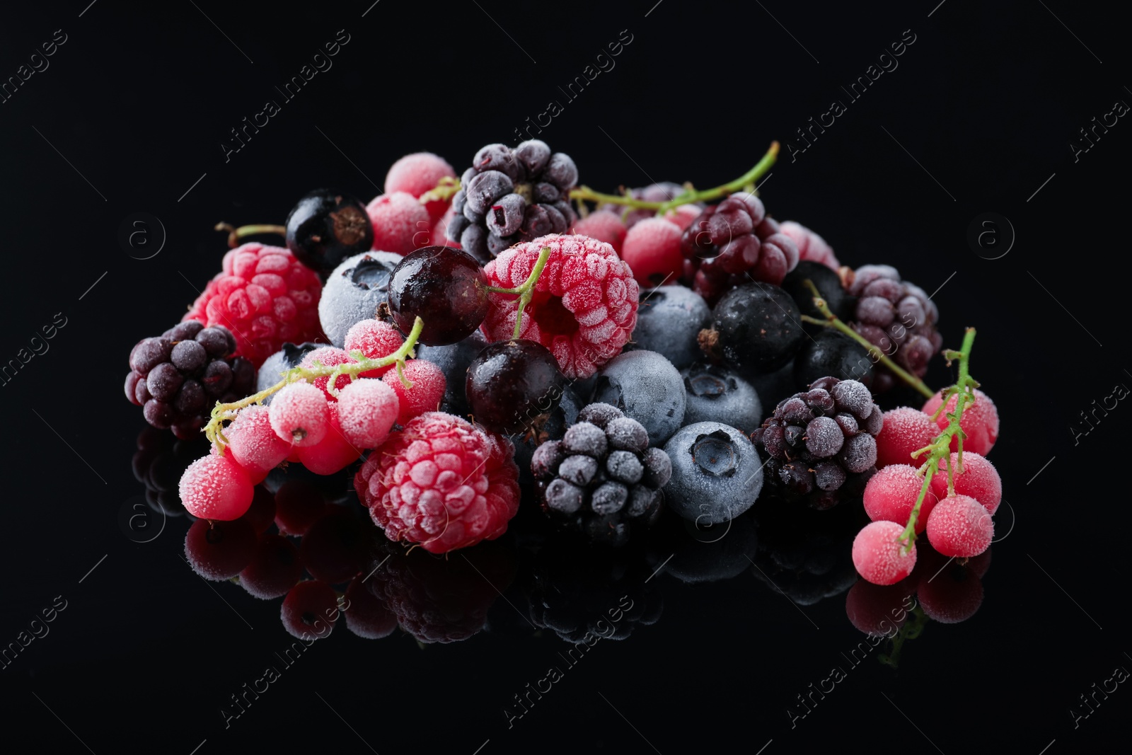 Photo of Many different frozen berries on black table, closeup