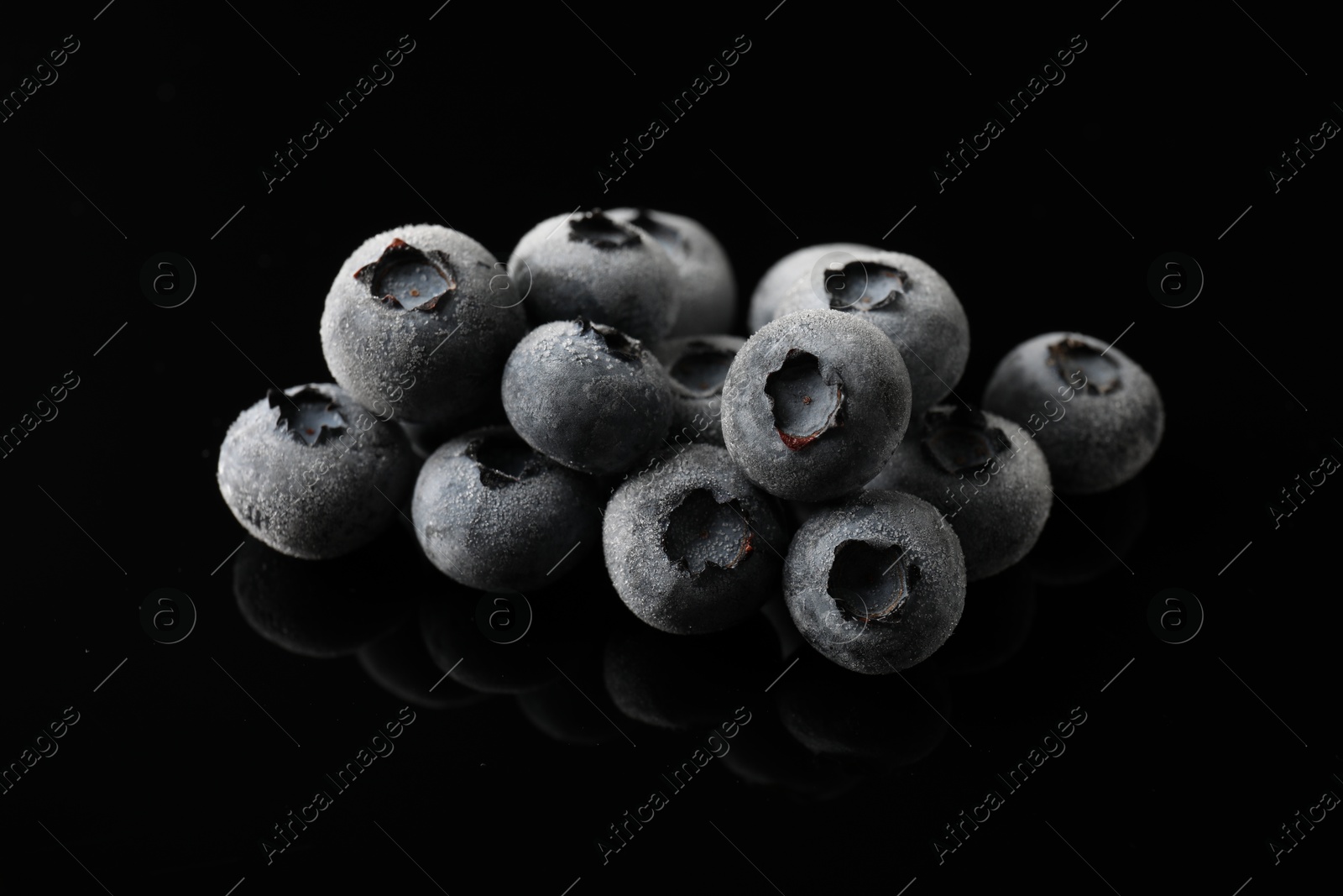 Photo of Many frozen blueberries on black table, closeup