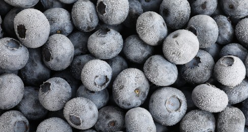 Photo of Many frozen blueberries as background, top view