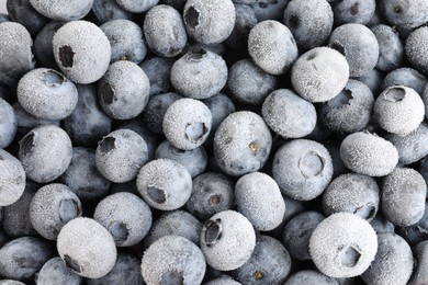 Photo of Many frozen blueberries as background, top view