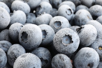Photo of Many frozen blueberries as background, closeup view