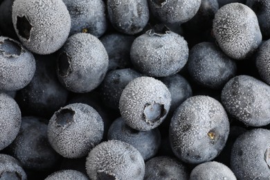 Photo of Many frozen blueberries as background, top view