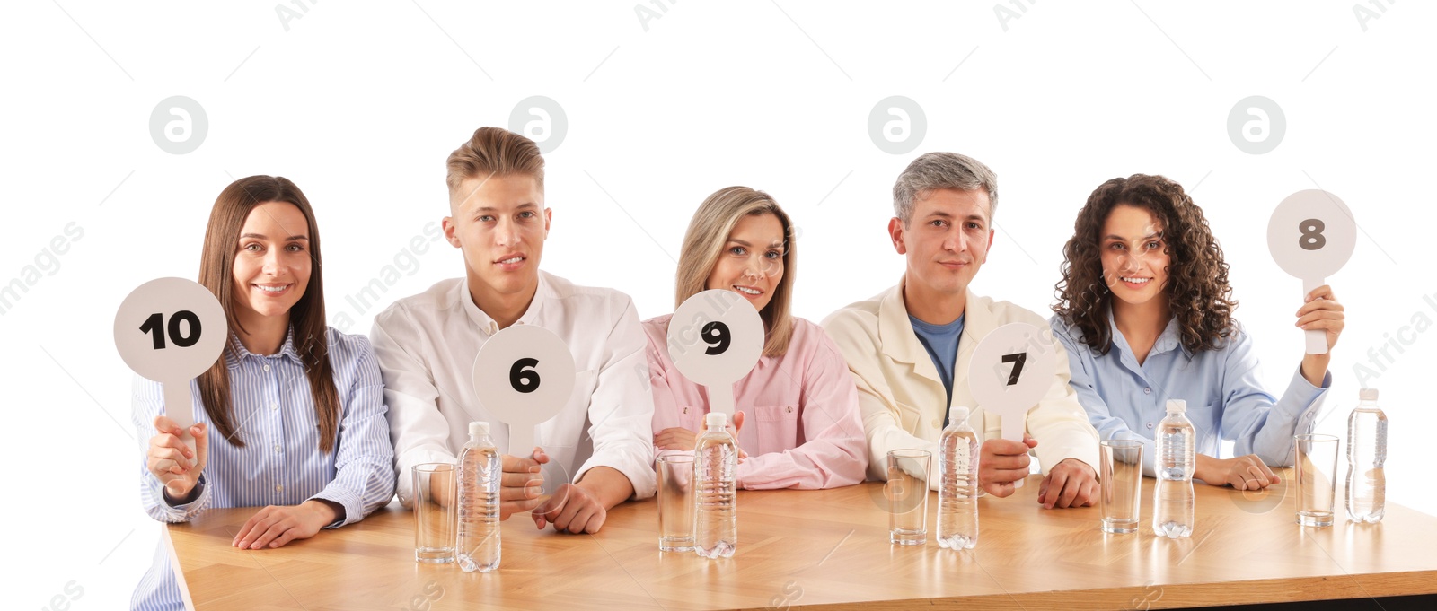 Panel of judges voting with score signs at table on white background Photo of Panel of judges voting with score signs at table on white background