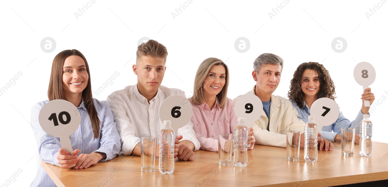 Panel of judges voting with score signs at table on white background Photo of Panel of judges voting with score signs at table on white background