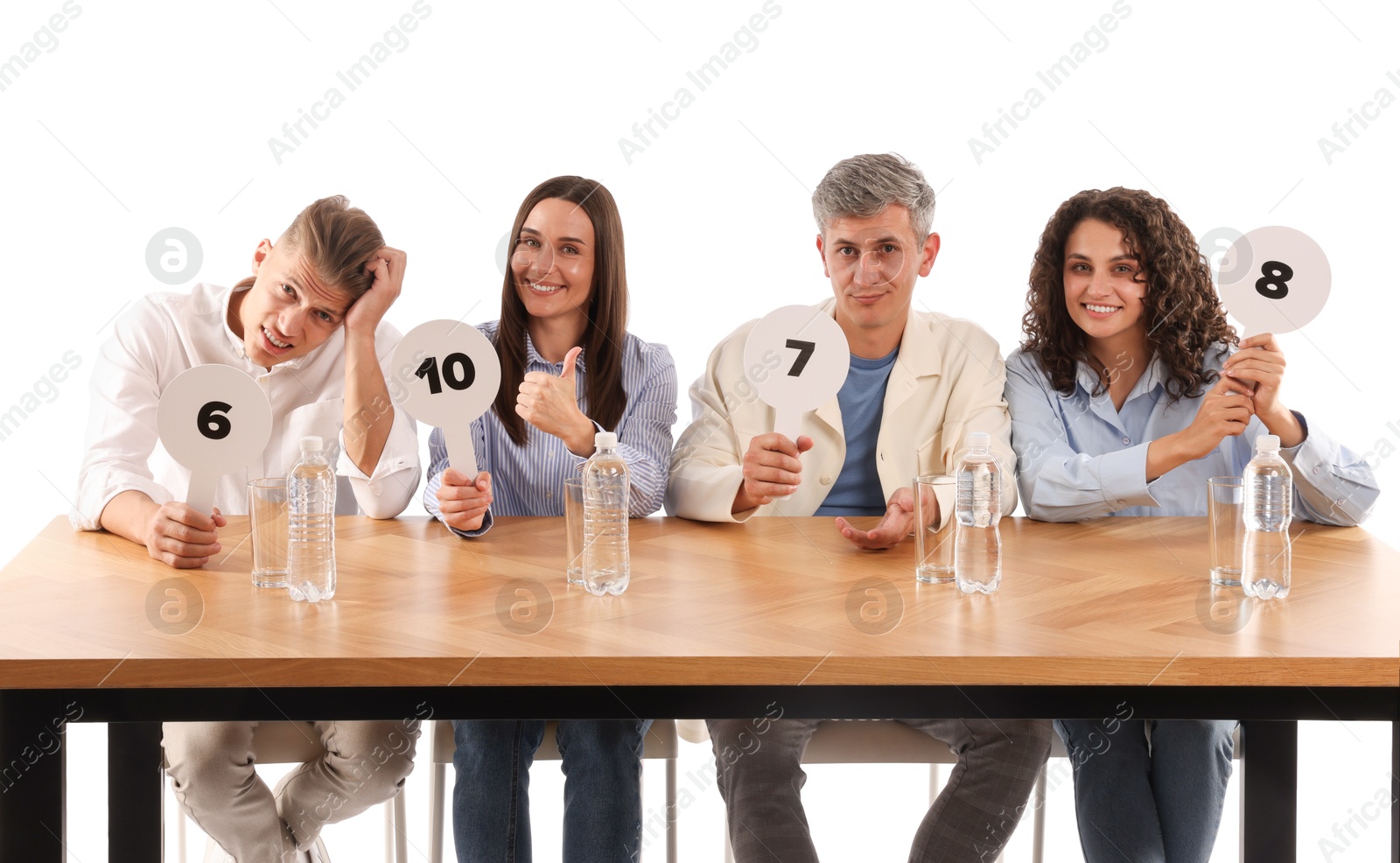Panel of judges voting with score signs at table on white background Photo of Panel of judges voting with score signs at table on white background