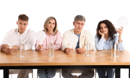 Photo of Panel of judges with blank score signs at table on white background