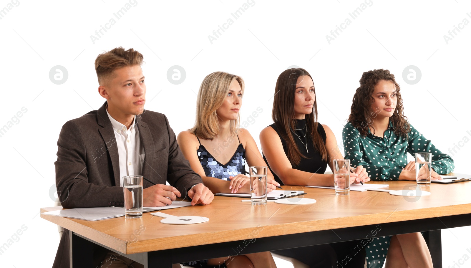 Panel of judges at table on white background Photo of Panel of judges at table on white background