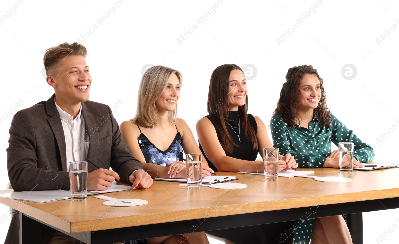 Panel of happy judges at table on white background Photo of Panel of happy judges at table on white background