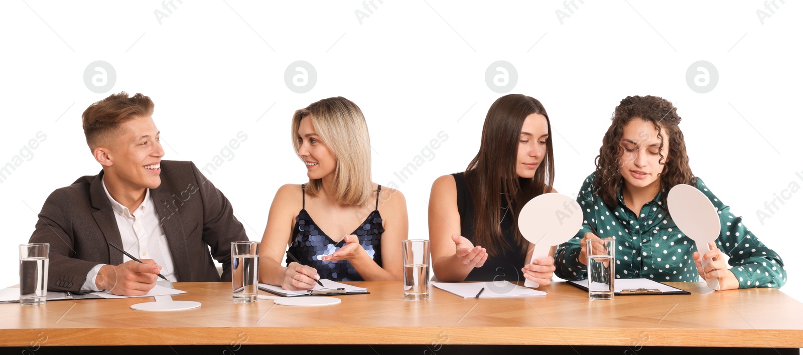 Panel of happy judges consulting at table on white background Photo of Panel of happy judges consulting at table on white background