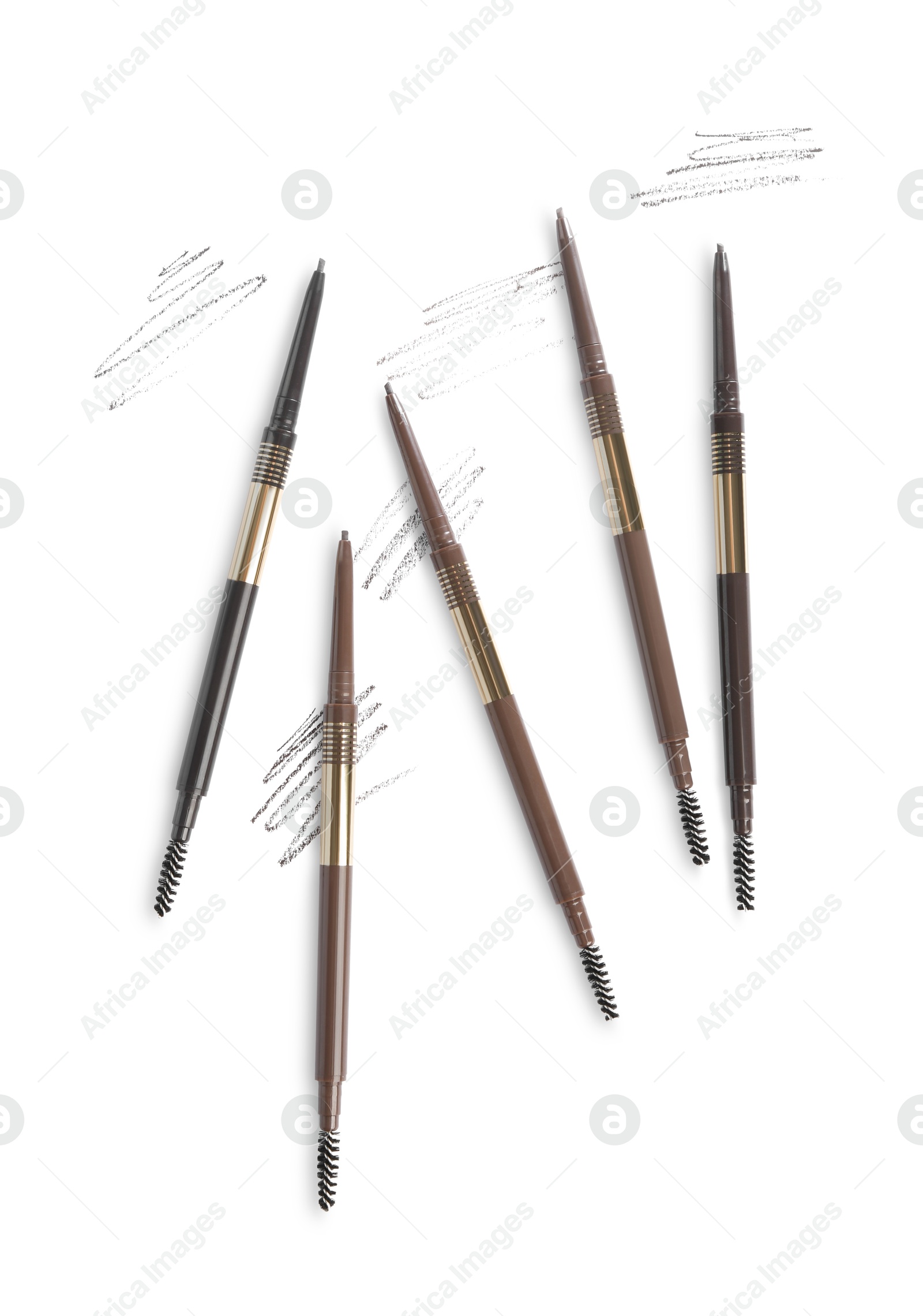 Eyebrow pencils and strokes isolated on white, top view Photo of Eyebrow pencils and strokes isolated on white, top view