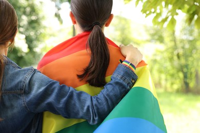 Photo of LGBT concept. Women with rainbow flag outdoors, closeup