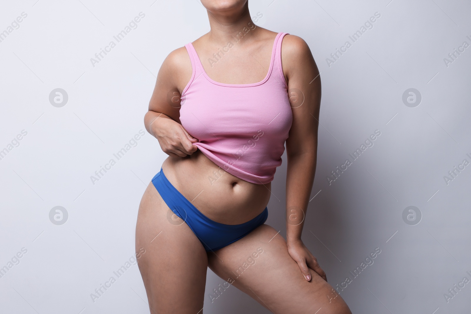 Photo of Liposuction. Woman in underwear on light grey background, closeup
