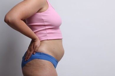 Photo of Liposuction. Woman in underwear on light grey background, closeup. Space for text