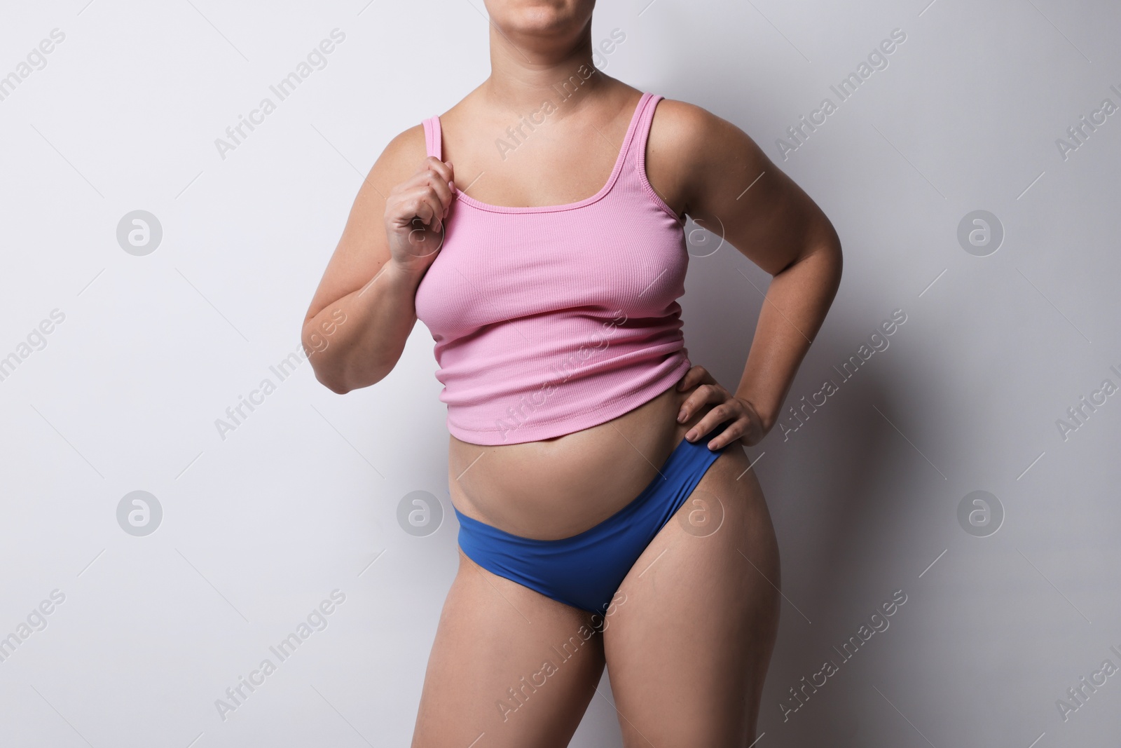 Photo of Liposuction. Woman in underwear on light grey background, closeup