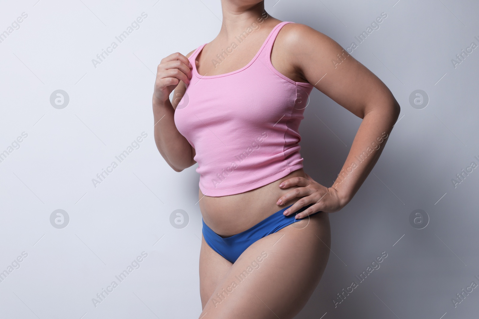 Photo of Liposuction. Woman in underwear on light grey background, closeup