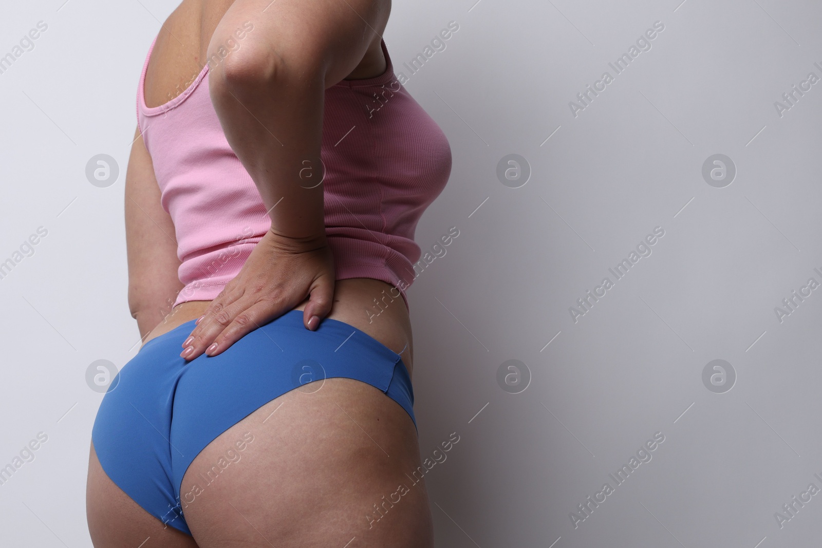 Photo of Liposuction. Woman in underwear on light grey background, closeup. Space for text