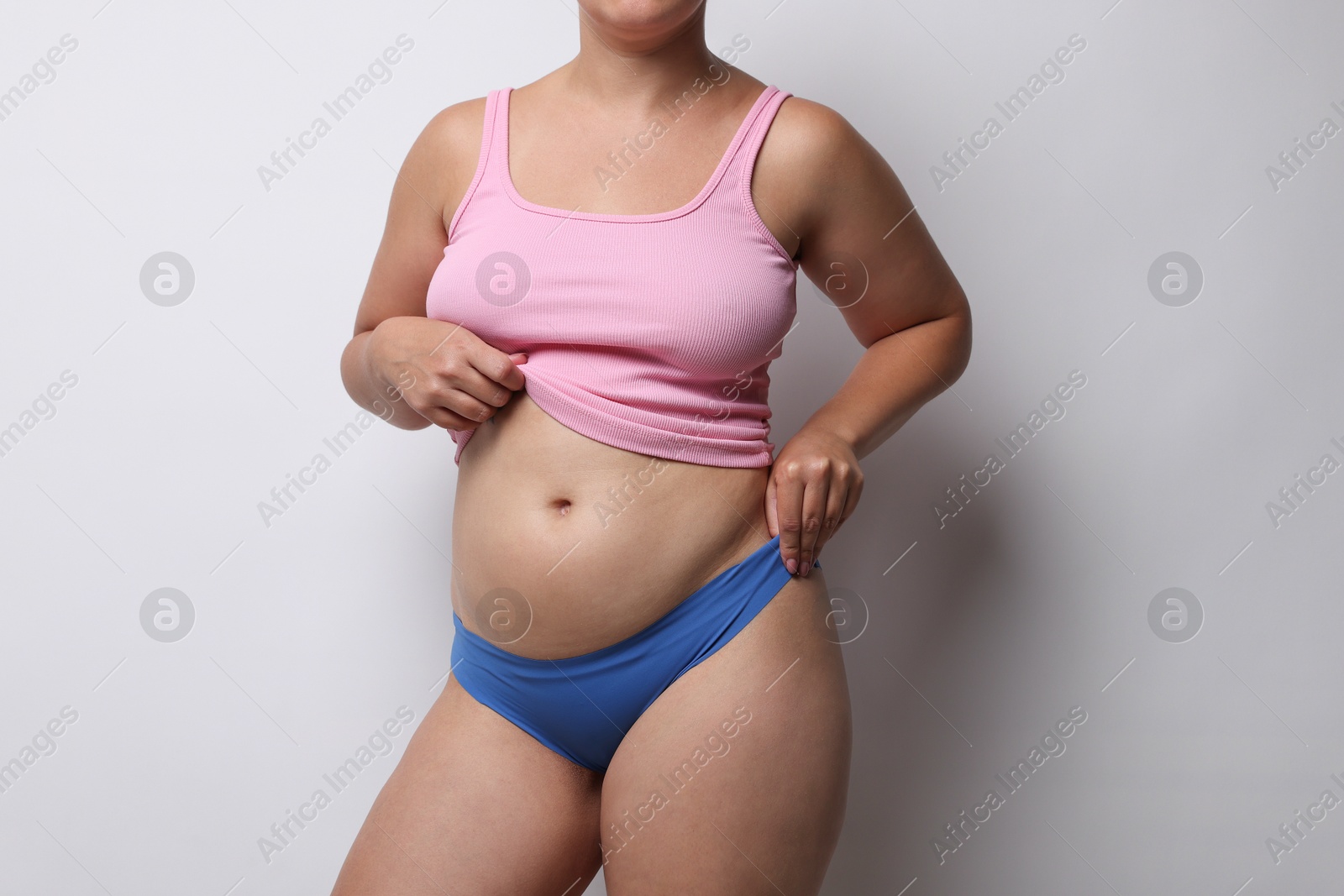 Photo of Liposuction. Woman in underwear on light grey background, closeup