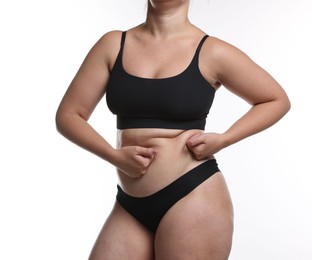Photo of Liposuction. Woman in underwear touching her belly on white background, closeup